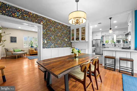 a view of a dining room with furniture wooden floor and chandelier
