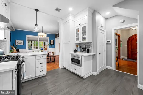 a view of kitchen with stainless steel appliances granite countertop a stove and a refrigerator