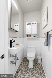 a bathroom with a sink toilet a mirror and vanity