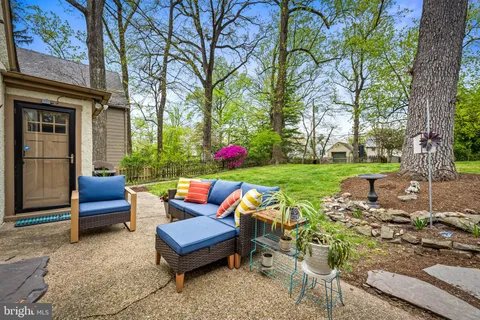 a view of a yard with furniture and garden