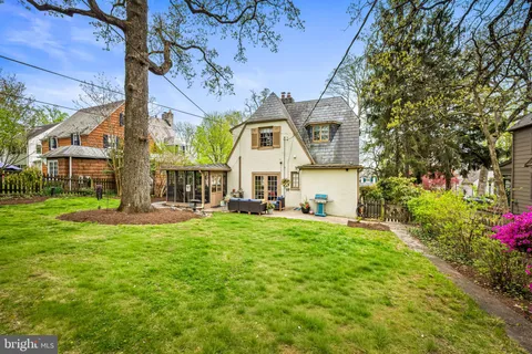 a house view with a sitting space and garden