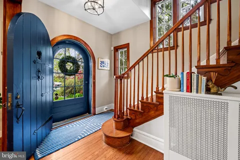 a view of staircase with wooden floor and a large window