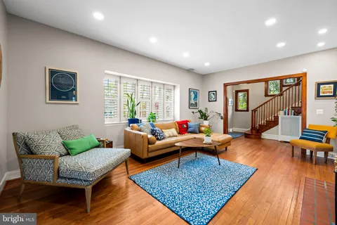 a living room with furniture and wooden floor