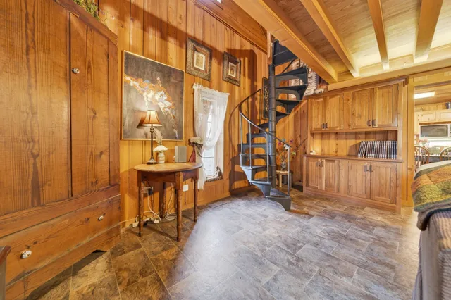 a spacious bedroom with a bed and a table