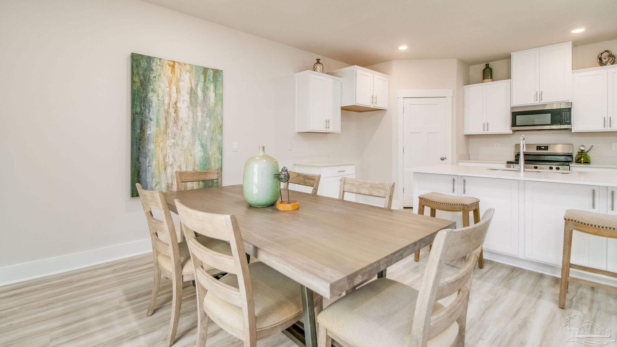 5860 Dove Nest Road Gulf Breeze, FL 32563 - Photo 6 of 31 a view of kitchen with cabinets table and chairs