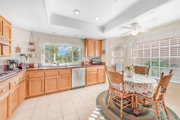 24941 Danamaple Dana Point, CA 92629 - Photo 5 of 28 a large kitchen with granite countertop lots of white cabinets a dining table and chairs
