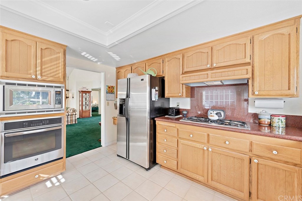 24941 Danamaple Dana Point, CA 92629 - Photo 8 of 28 a kitchen with stainless steel appliances granite countertop a refrigerator sink and cabinets