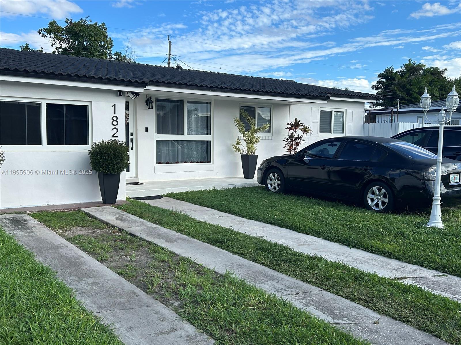 1821 Southwest 92nd Place Miami, FL 33165 - Photo 2 of 11 a front view of a house with a garden