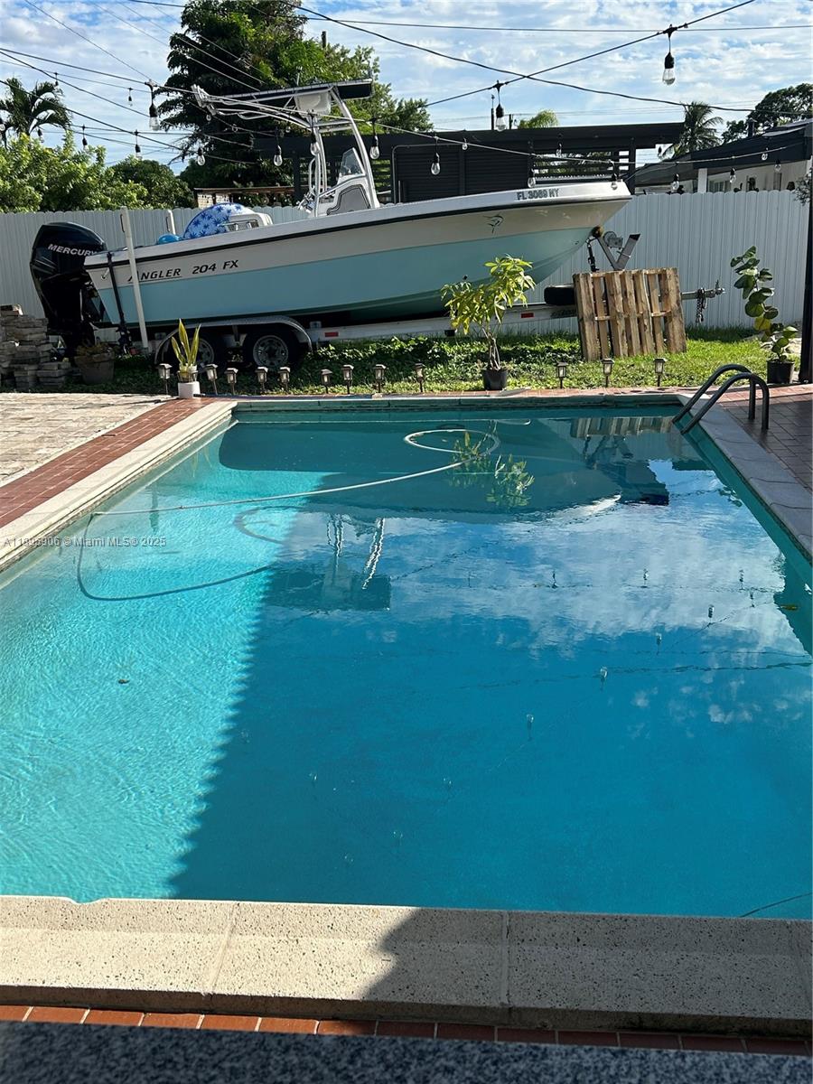 1821 Southwest 92nd Place Miami, FL 33165 - Photo 4 of 11 a view of a swimming pool with a patio
