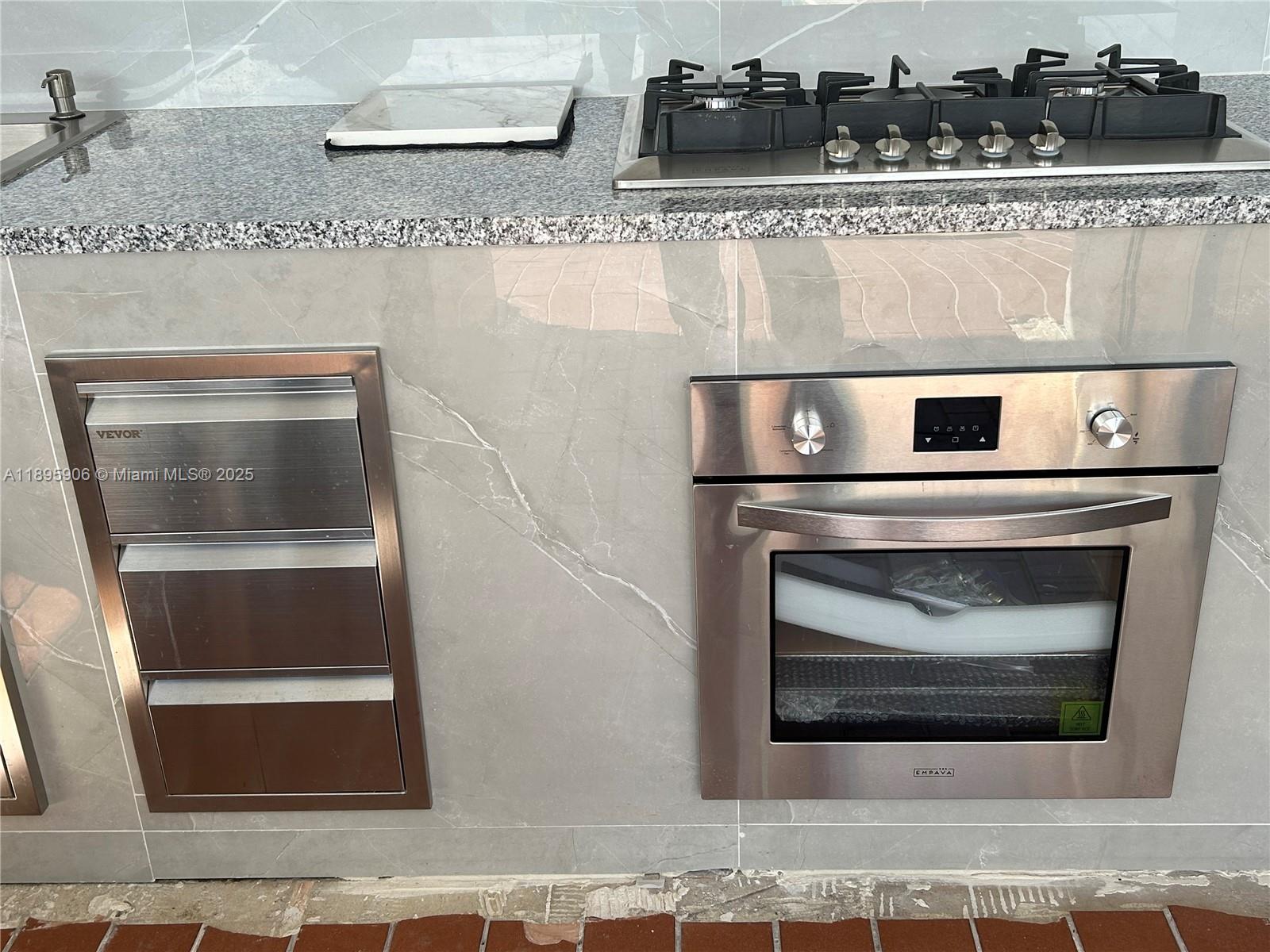 1821 Southwest 92nd Place Miami, FL 33165 - Photo 8 of 11 a stove top oven sitting inside of a kitchen