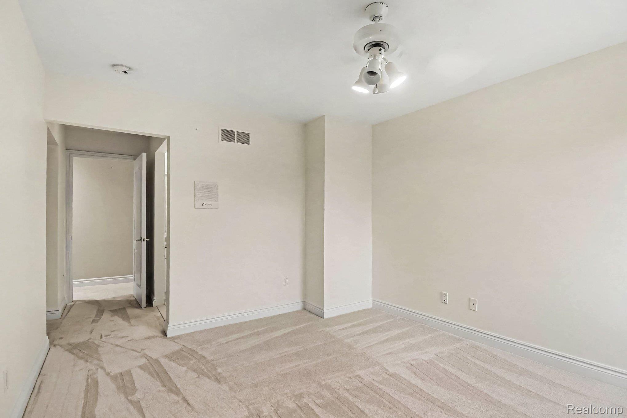 4875 Green Meadow Lane Rochester, MI 48306 - Photo 27 of 60 Neutral wall tones with a ceiling-mounted light fixture and carpeted flooring
