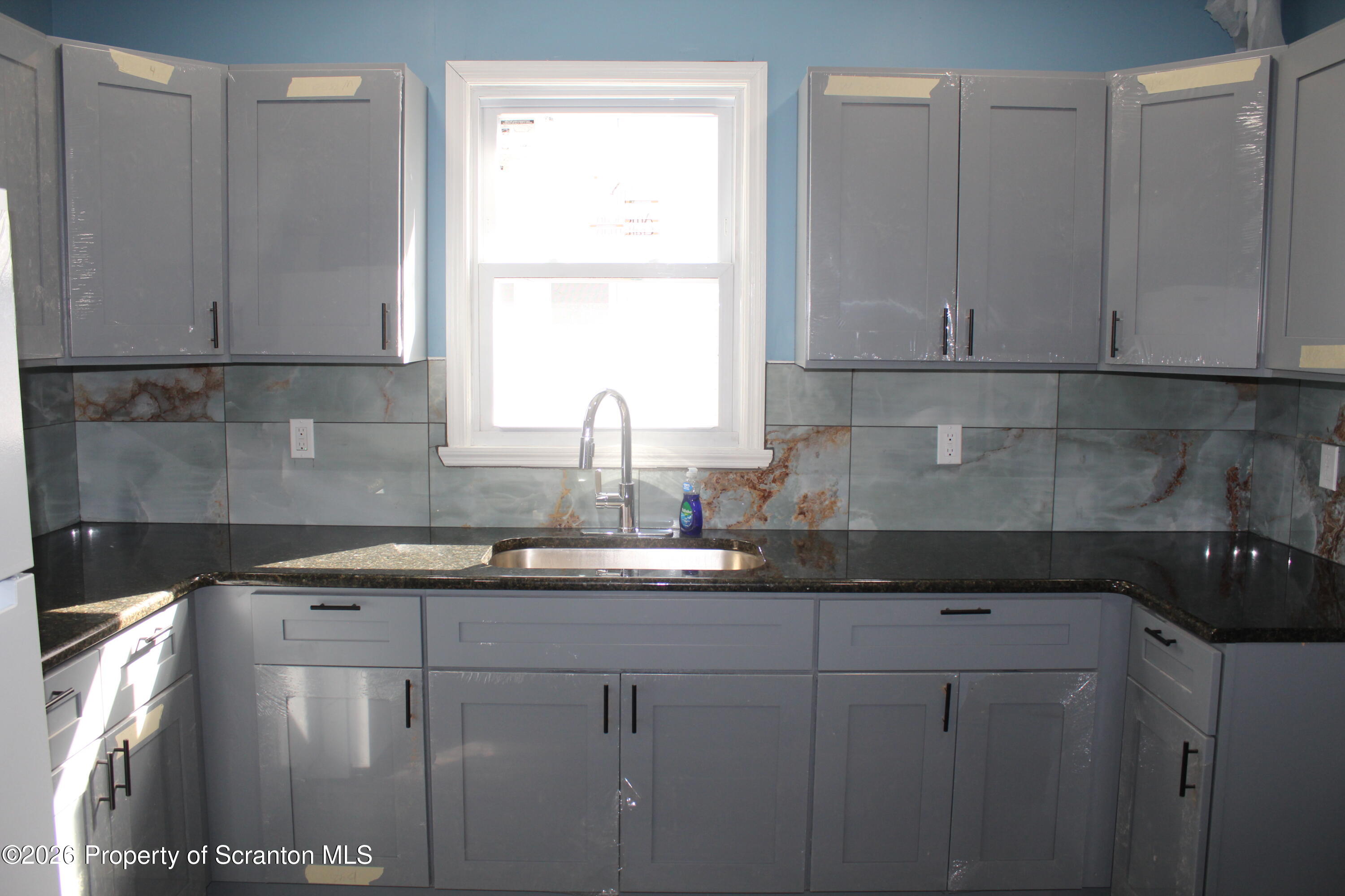 335 Phelps Street, Unit 1 Scranton, PA 18509 - Photo 4 of 12 a kitchen with a sink and cabinets