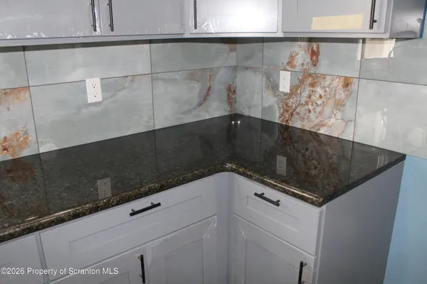 a close view of kitchen stove and cabinets