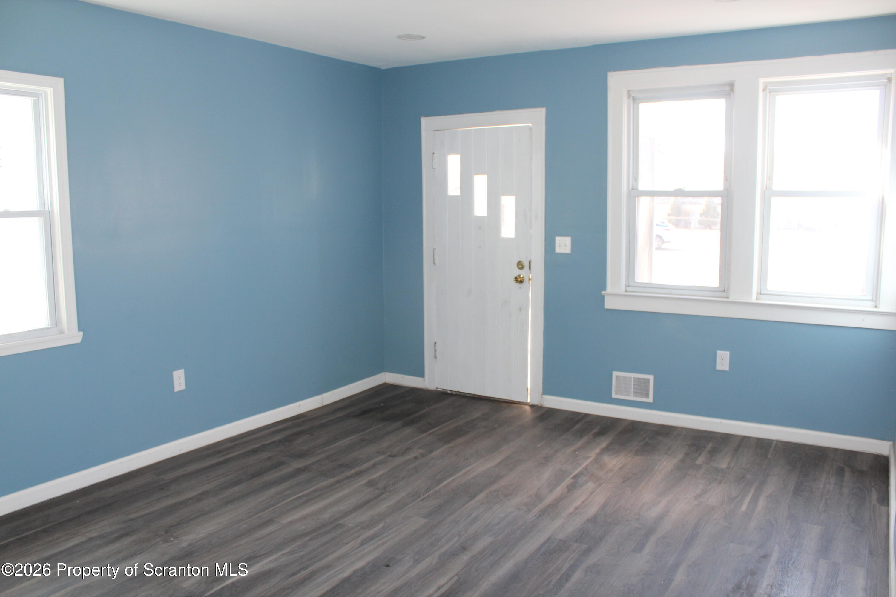 335 Phelps Street, Unit 1 Scranton, PA 18509 - Photo 7 of 12 an empty room with wooden floor and windows