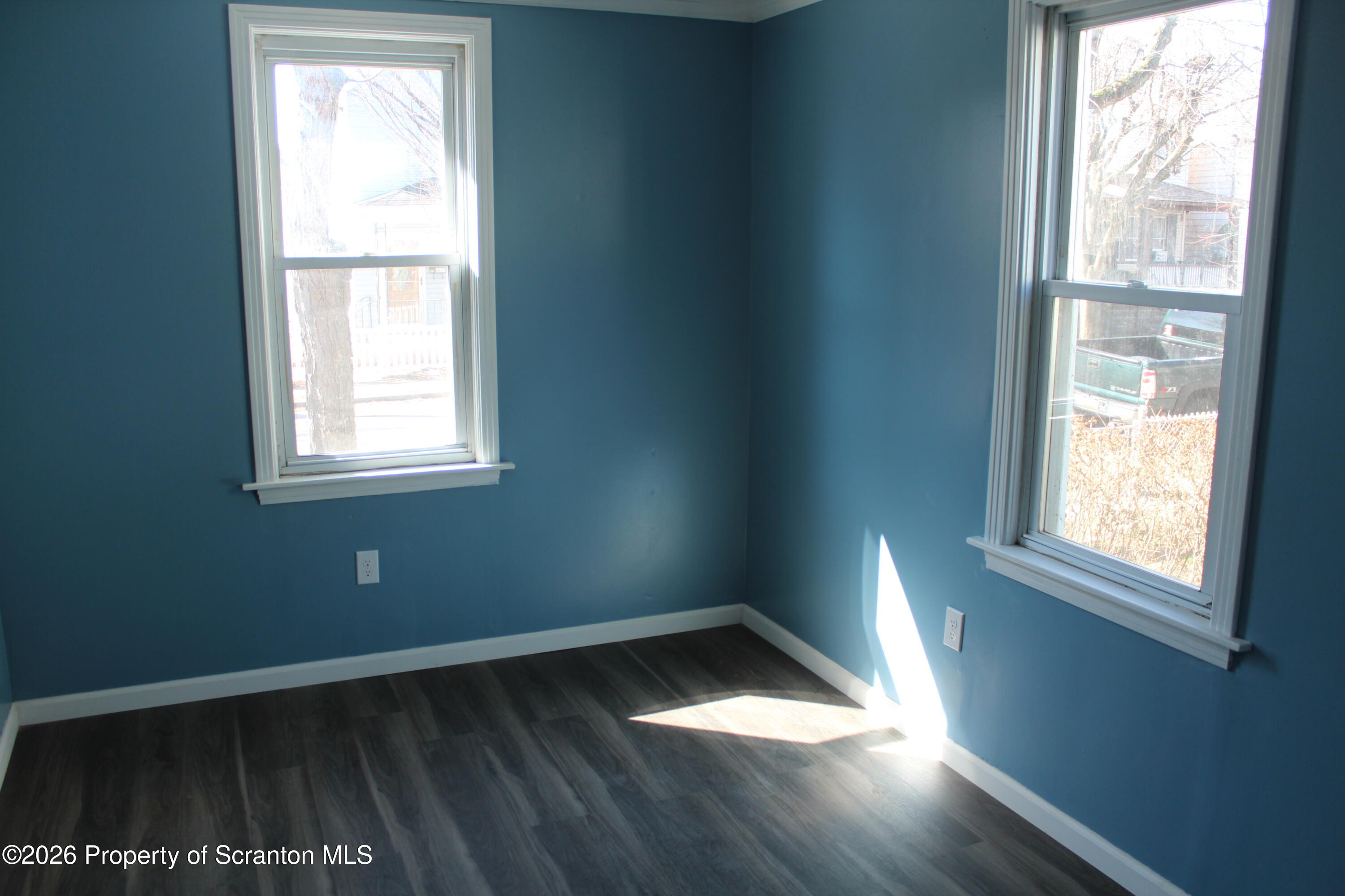 335 Phelps Street, Unit 1 Scranton, PA 18509 - Photo 10 of 12 an empty room with wooden floor and windows