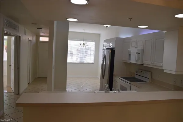a kitchen with kitchen island a counter top space and a sink