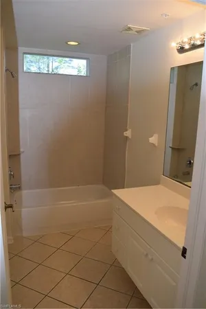 a bathroom with a shower and a sink