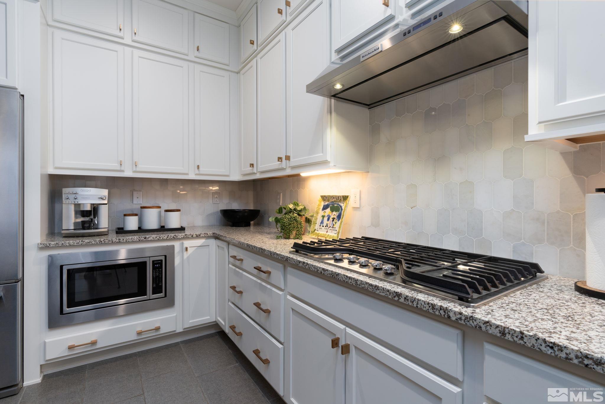 2343 Iron Square Drive Reno, NV 89521 - Photo 11 of 35 a kitchen with white cabinets and appliances