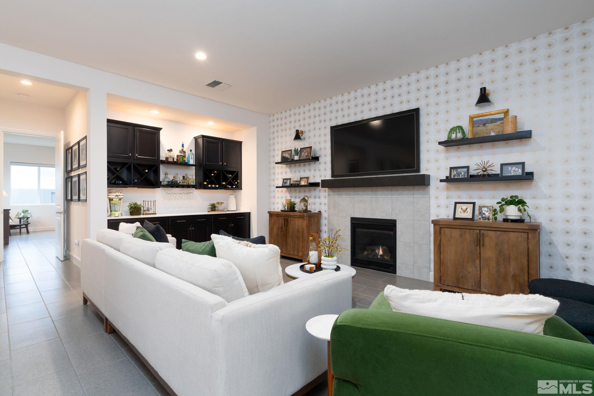 2343 Iron Square Drive Reno, NV 89521 - Photo 12 of 35 a living room with furniture a flat screen tv and a fireplace