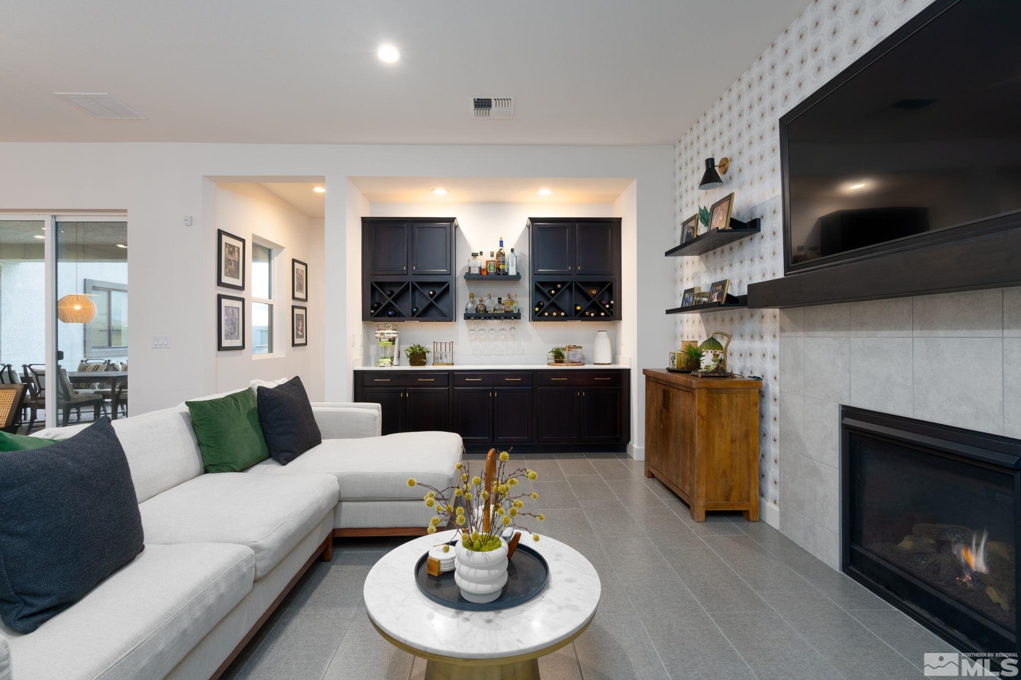 2343 Iron Square Drive Reno, NV 89521 - Photo 14 of 35 a living room with furniture a fireplace and a flat screen tv