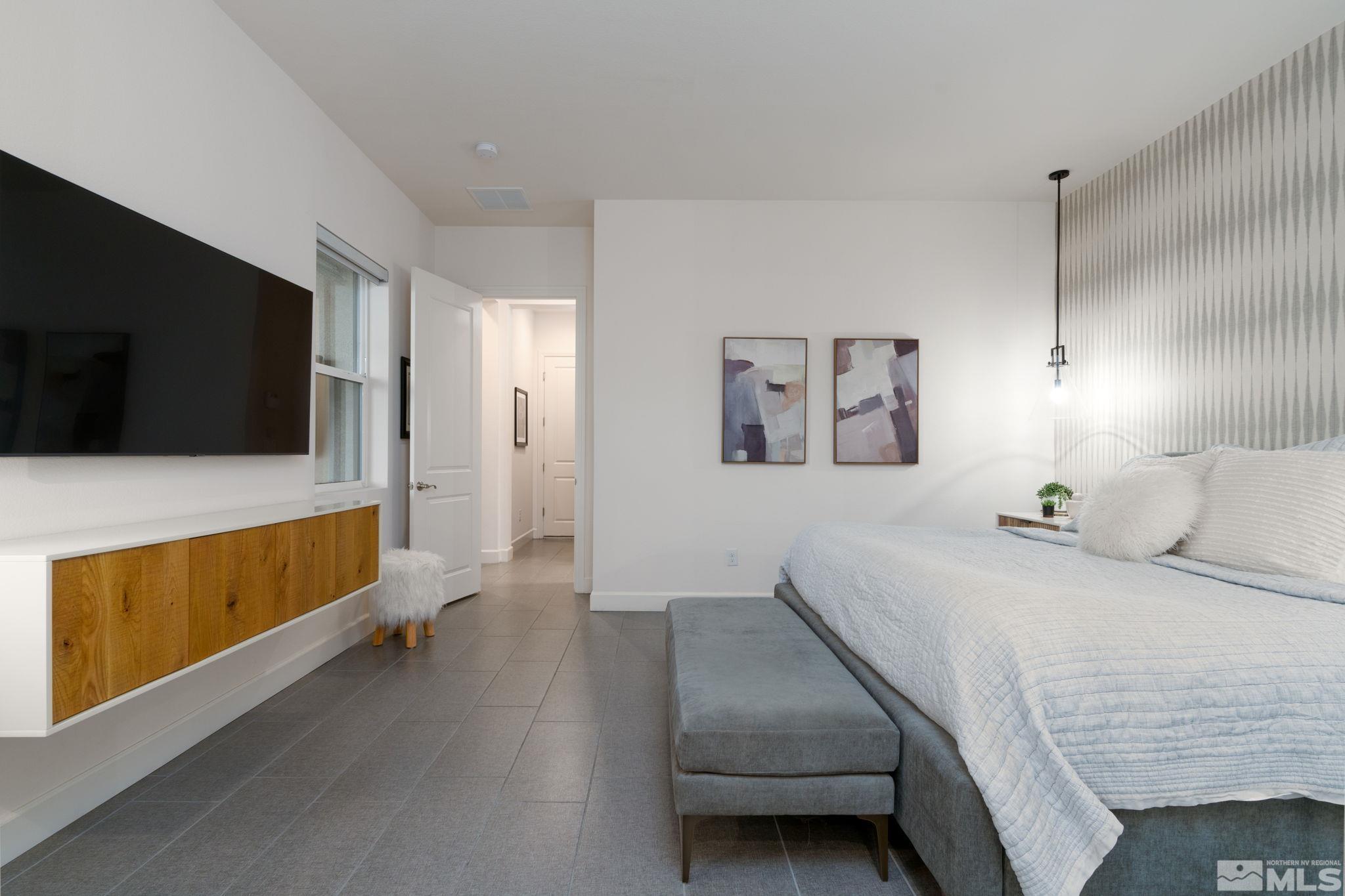 2343 Iron Square Drive Reno, NV 89521 - Photo 16 of 35 a bedroom with a bed and a flat screen tv