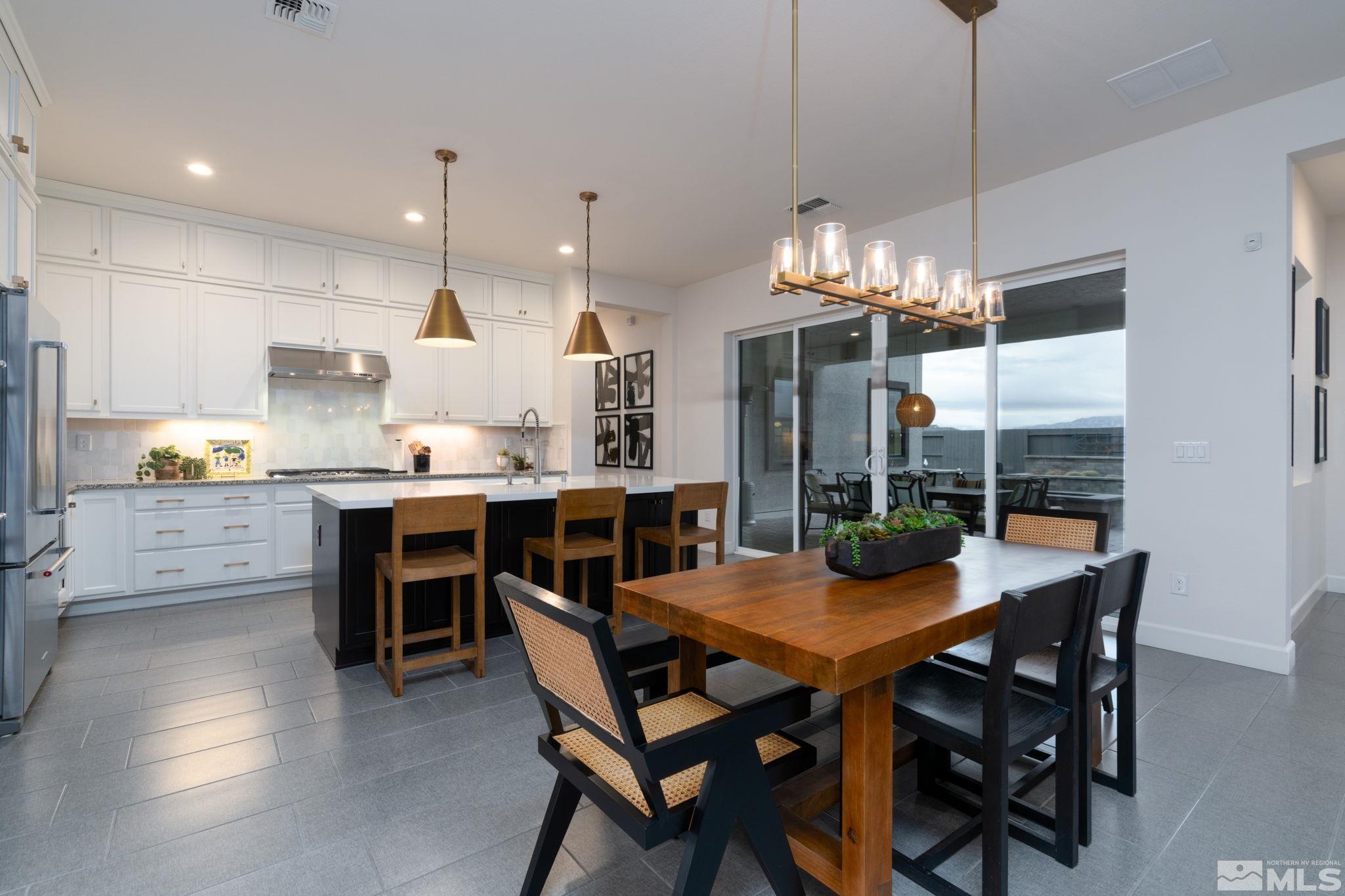 2343 Iron Square Drive Reno, NV 89521 - Photo 6 of 35 a view of a dining room and livingroom with furniture wooden floor a chandelier