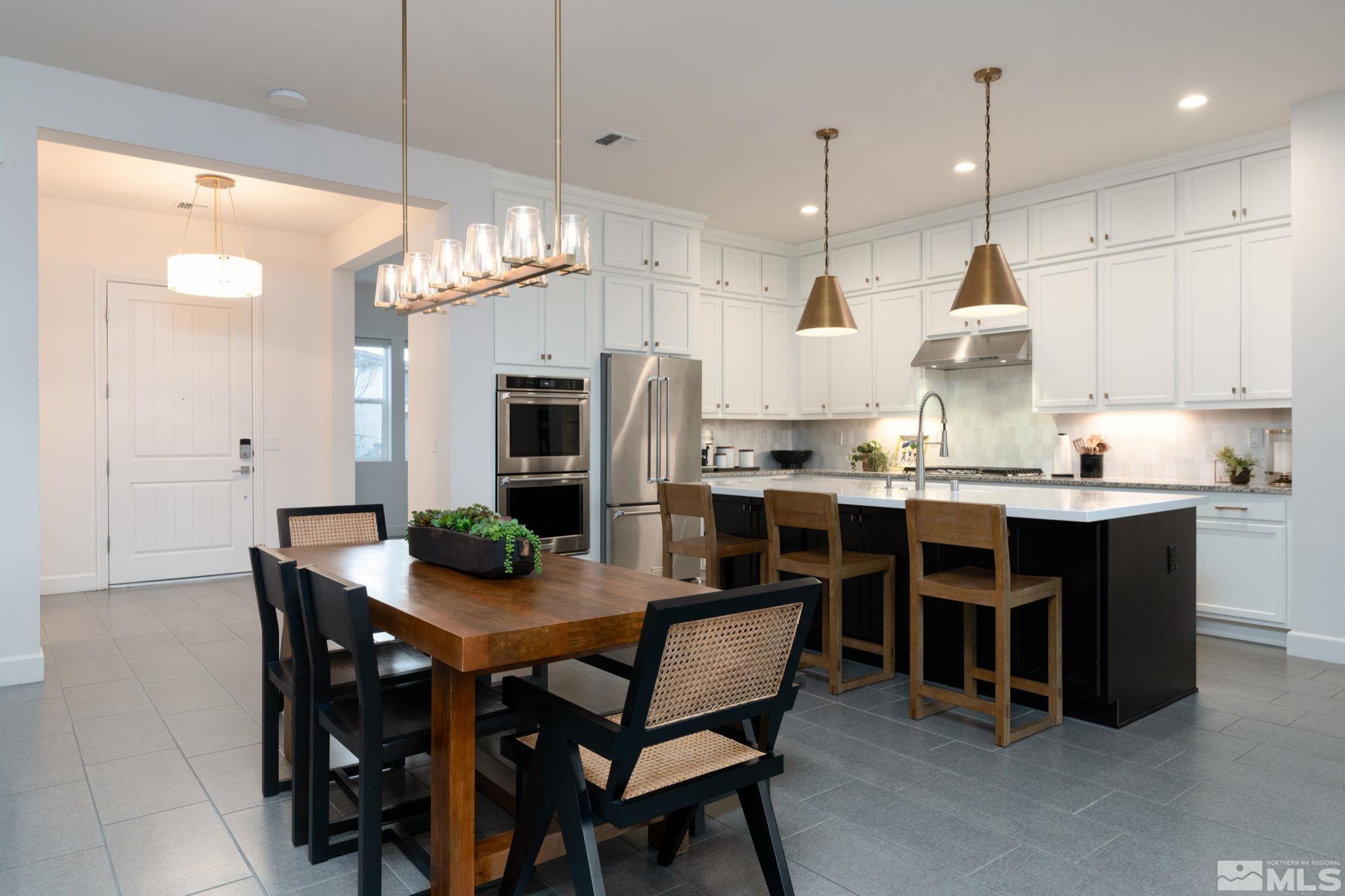 2343 Iron Square Drive Reno, NV 89521 - Photo 7 of 35 a kitchen with kitchen island a dining table and chairs