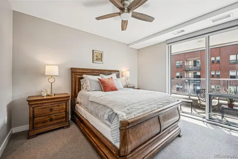 a bed sitting in a room next to a lamp and a chandelier