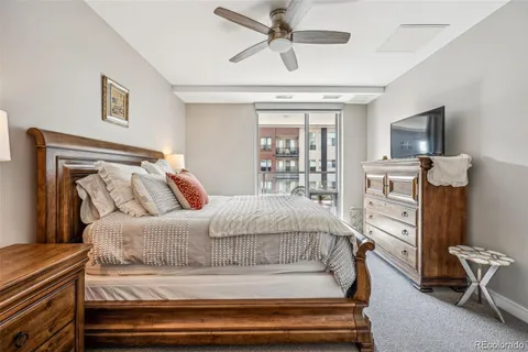 a bedroom with a bed and a flat tv screen