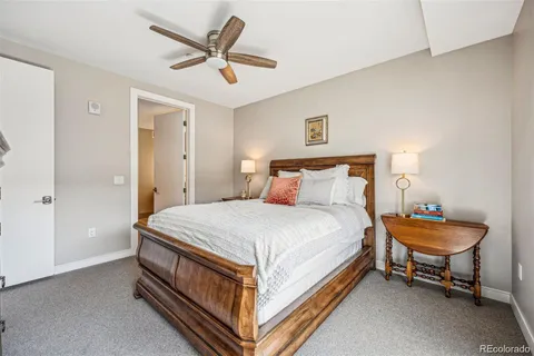 a bedroom with a bed and a ceiling fan