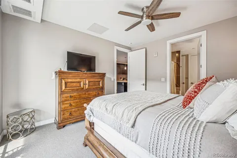 a bedroom with a bed and a television