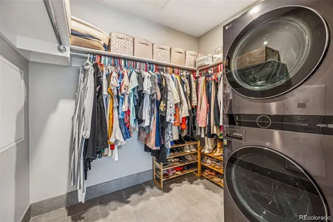 a view of walk in closet with clothes and shoes