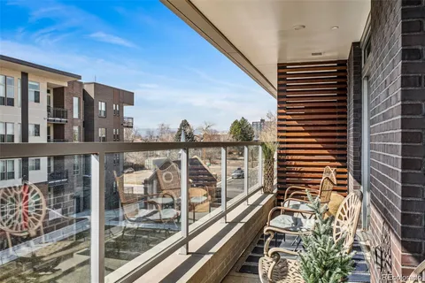 a view of a balcony with floor to ceiling windows and wooden floor