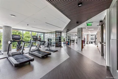 a living room with furniture and floor to ceiling window