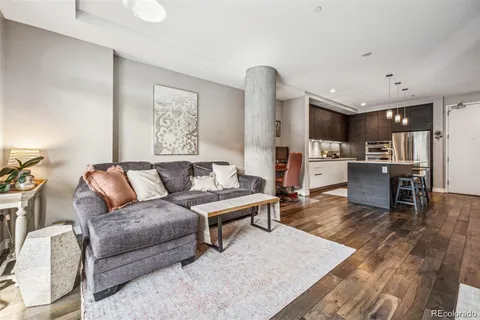 a living room with furniture and kitchen view