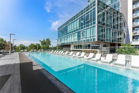 a view of building with swimming pool and outdoor space