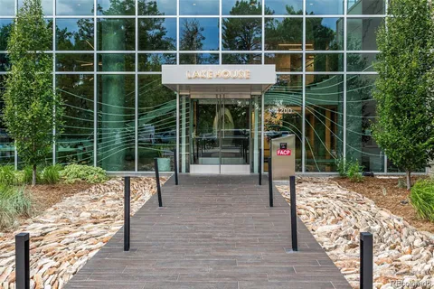 a view of a room with wooden floor and a potted plant
