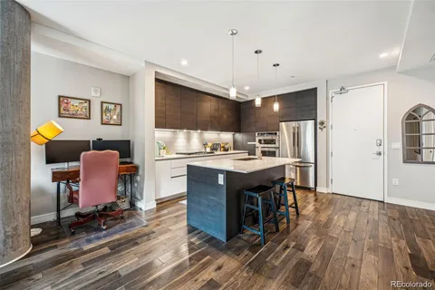 a kitchen with stainless steel appliances granite countertop a sink refrigerator and cabinets