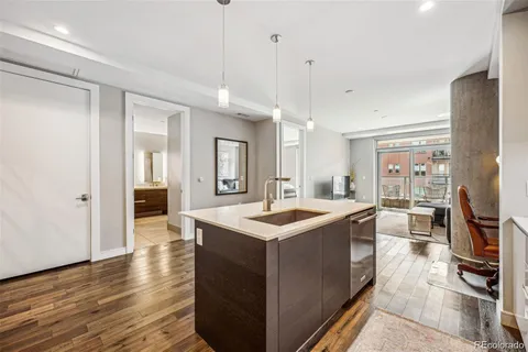 a kitchen with stainless steel appliances granite countertop a sink and a refrigerator