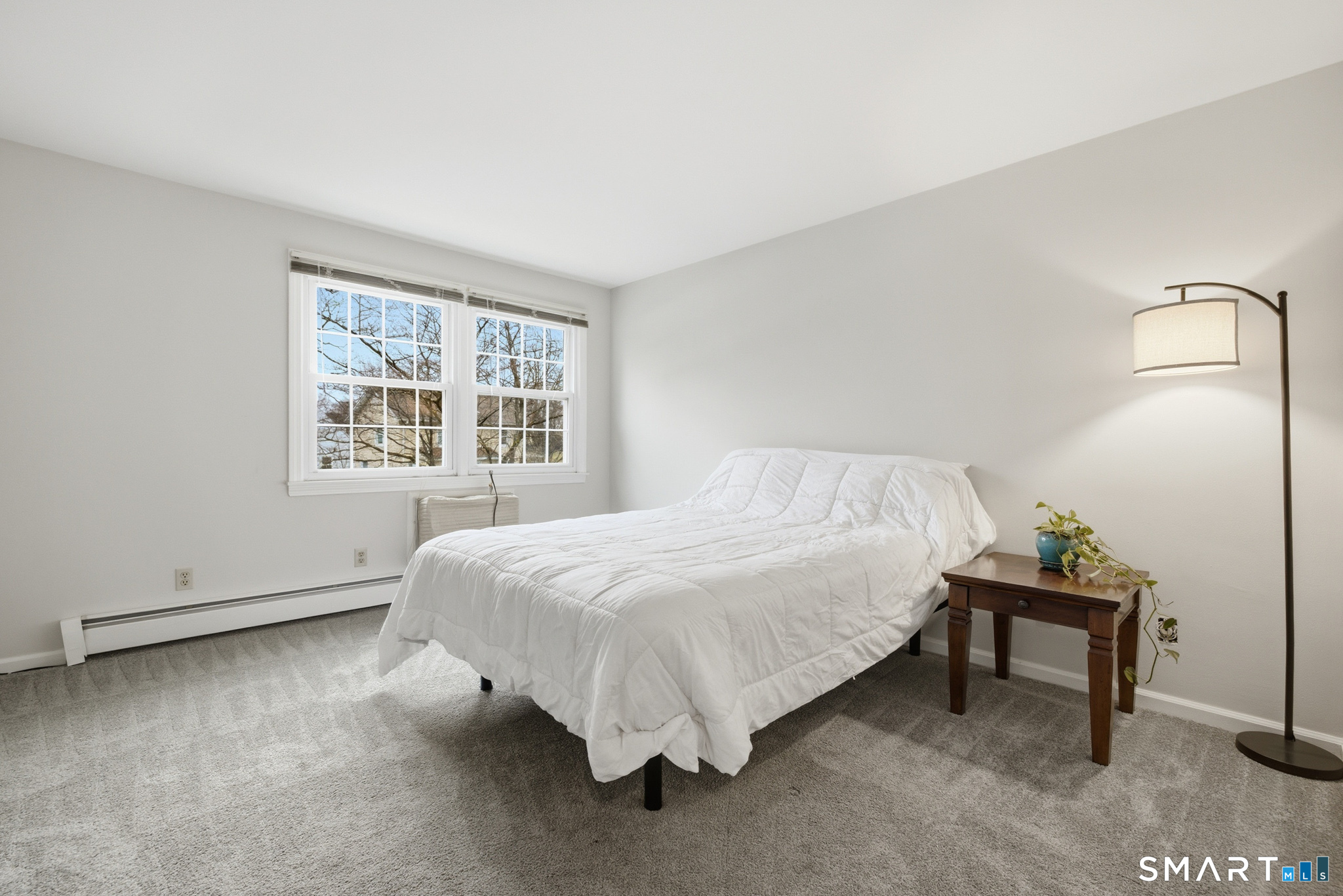 36 Grove Street, Unit E Manchester, CT 06042 - Photo 12 of 31 a bed sitting in a bedroom next to a window