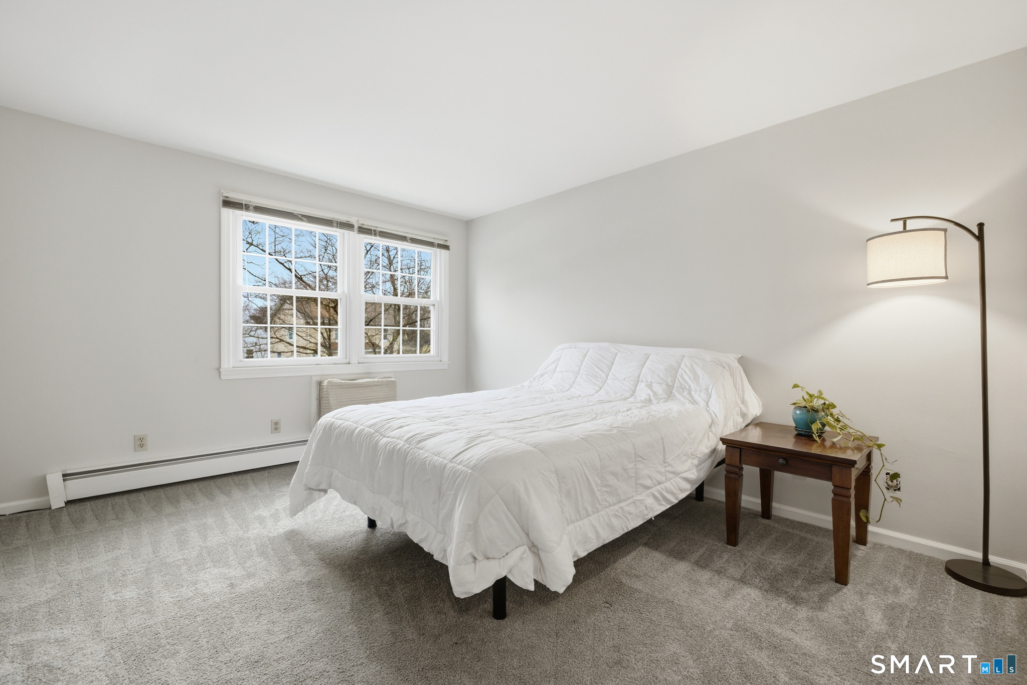 36 Grove Street, Unit E Manchester, CT 06042 - Photo 20 of 31 a bed sitting in a bedroom next to a window