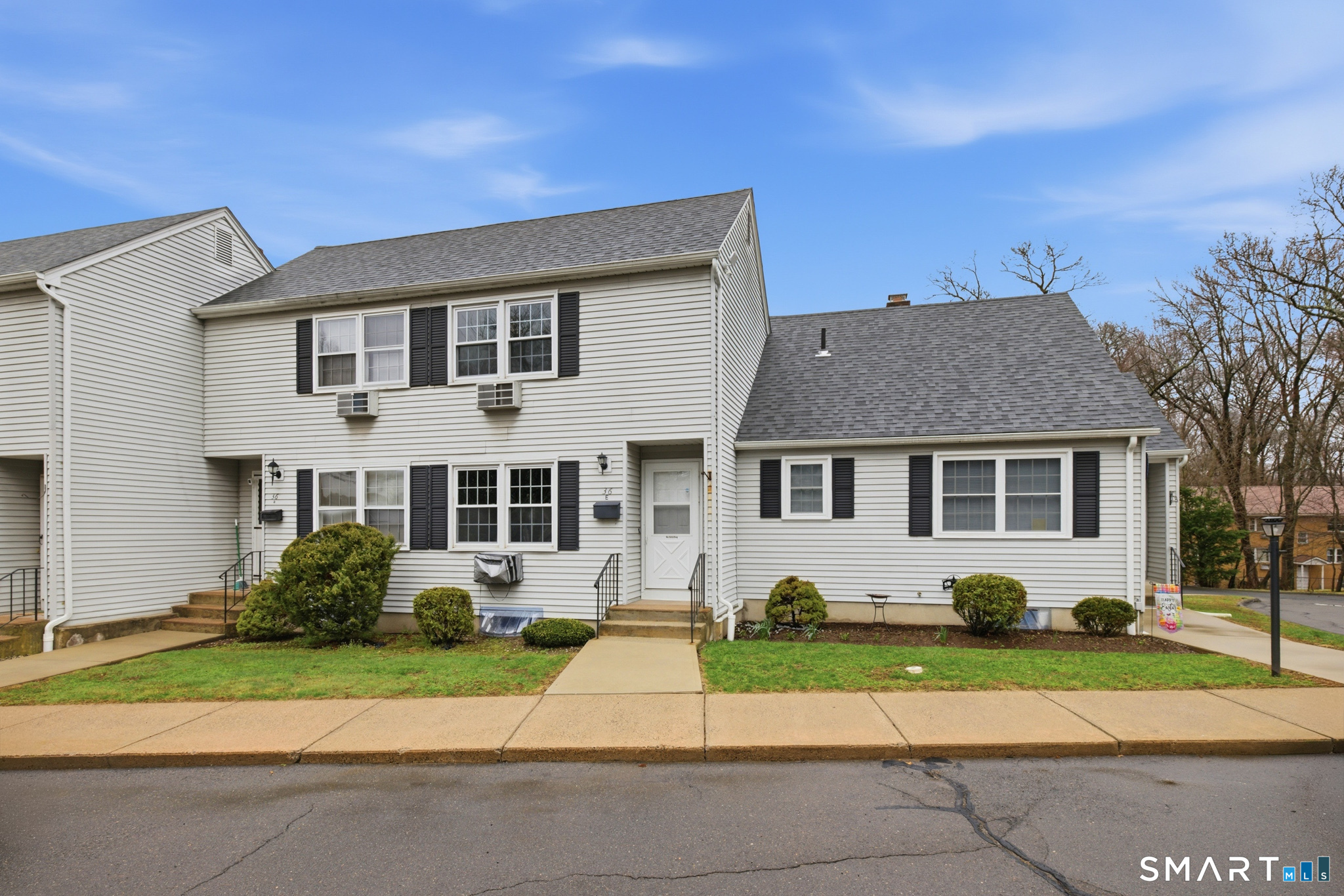36 Grove Street, Unit E Manchester, CT 06042 - Photo 2 of 31 a front view of a house with a yard and porch