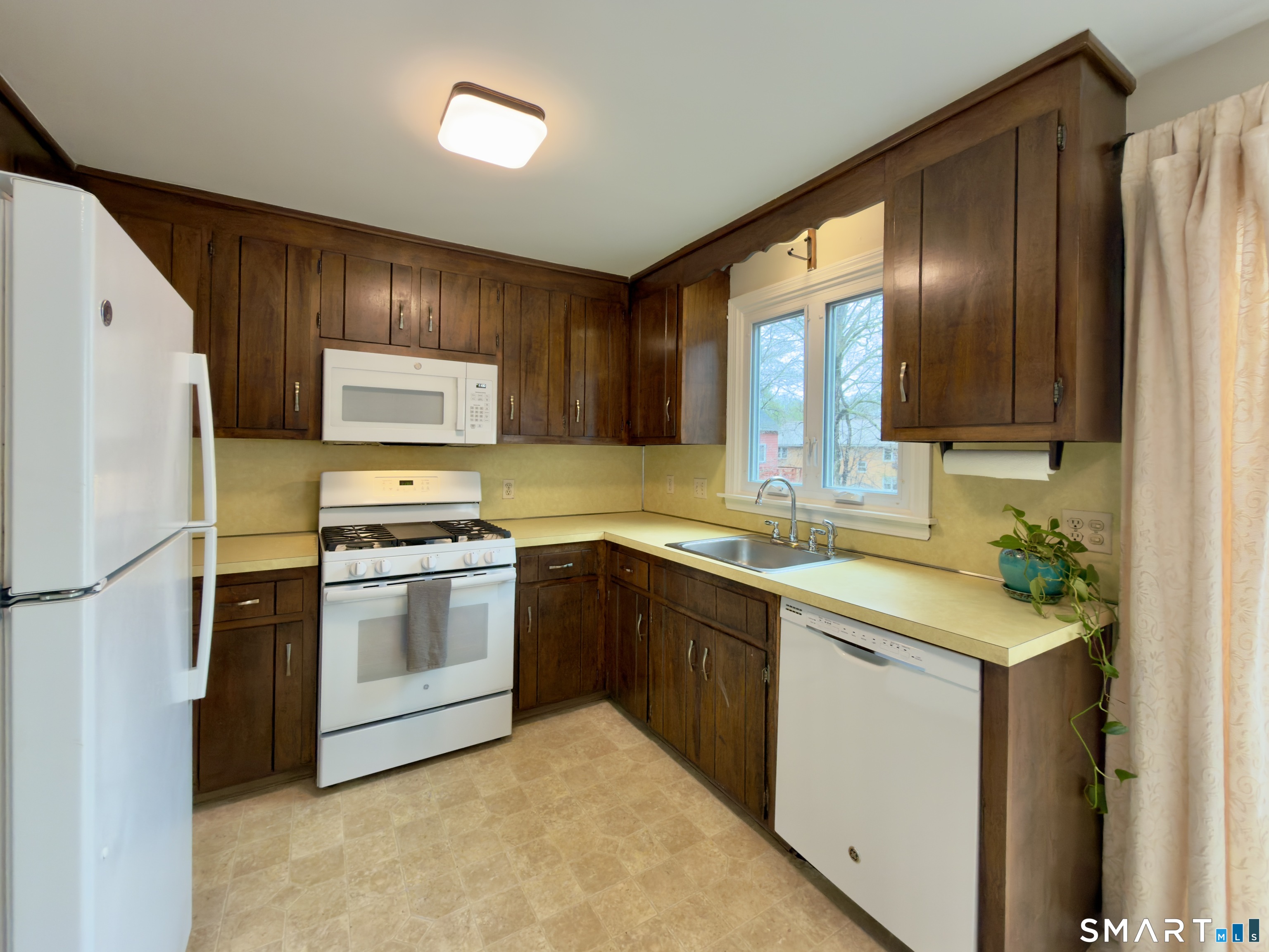 36 Grove Street, Unit E Manchester, CT 06042 - Photo 7 of 31 a kitchen with stainless steel appliances granite countertop a refrigerator stove and sink