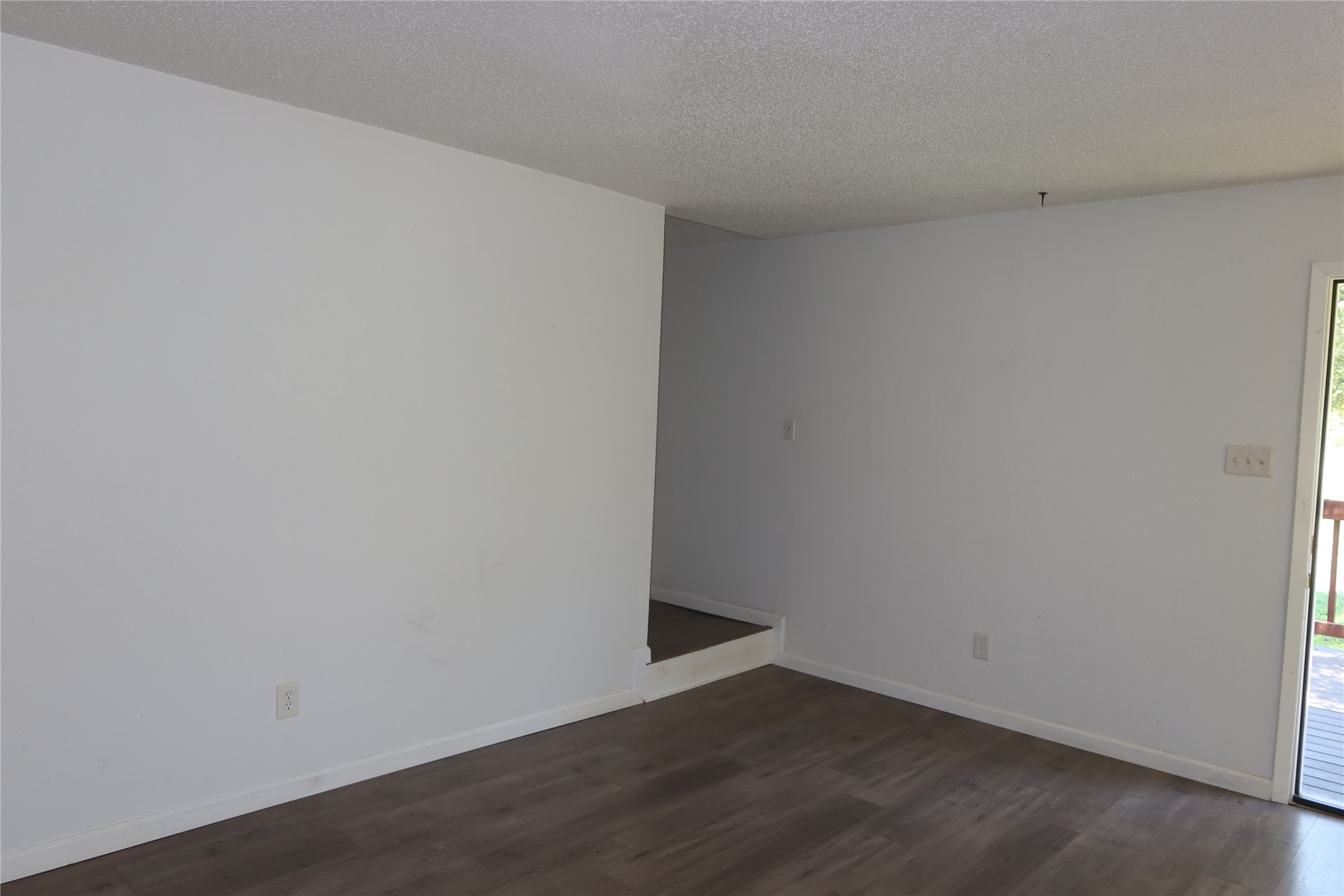 6914 Rifle Bend, Unit A Austin, TX 78736 - Photo 12 of 25 Smooth wood-look flooring and clean white walls anchor this versatile open living space.