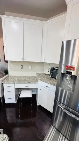 a kitchen with stainless steel appliances granite countertop a sink stove and cabinets