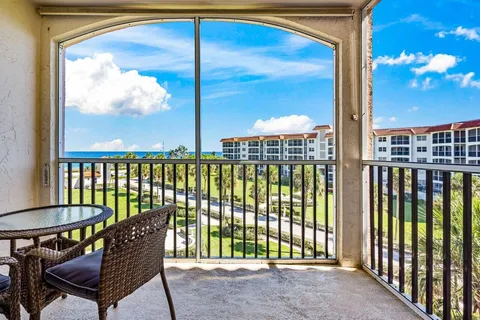 a view of a porch with a table and chairs