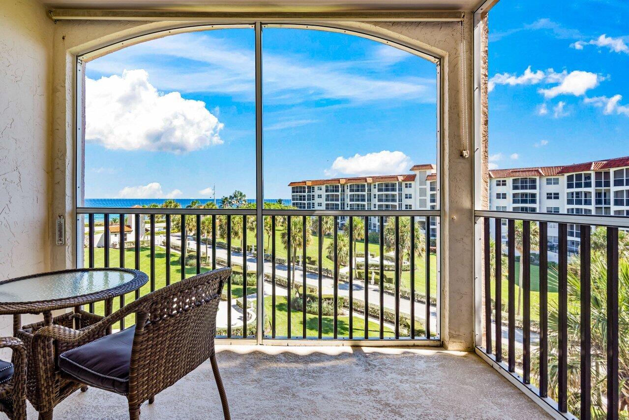 a view of a porch with a table and chairs