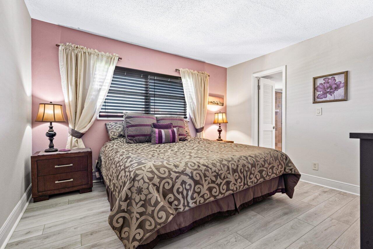 2871 North Ocean Boulevard, Unit C417 Boca Raton, FL 33431 - Photo 16 of 26 a bedroom with a bed and window