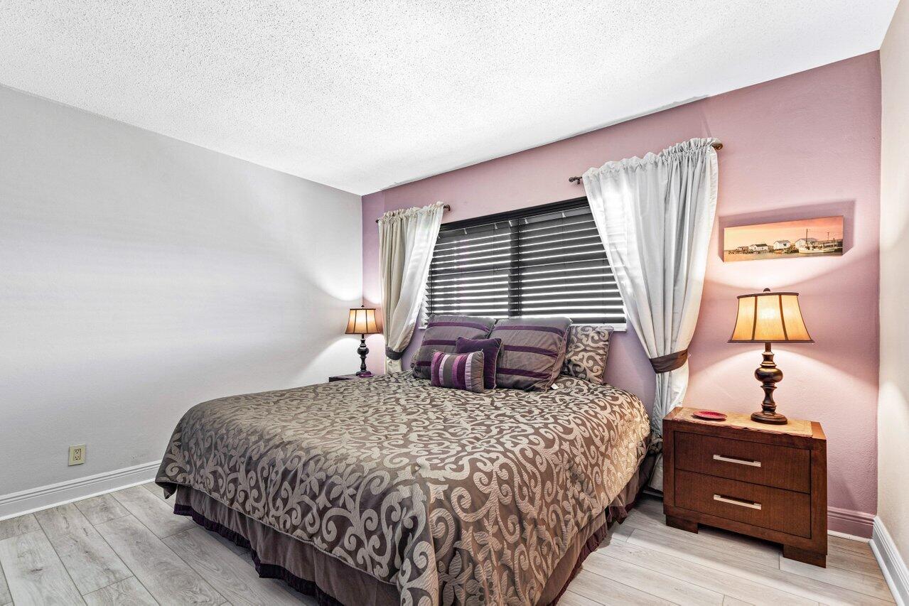 2871 North Ocean Boulevard, Unit C417 Boca Raton, FL 33431 - Photo 17 of 26 a bedroom with a bed and window