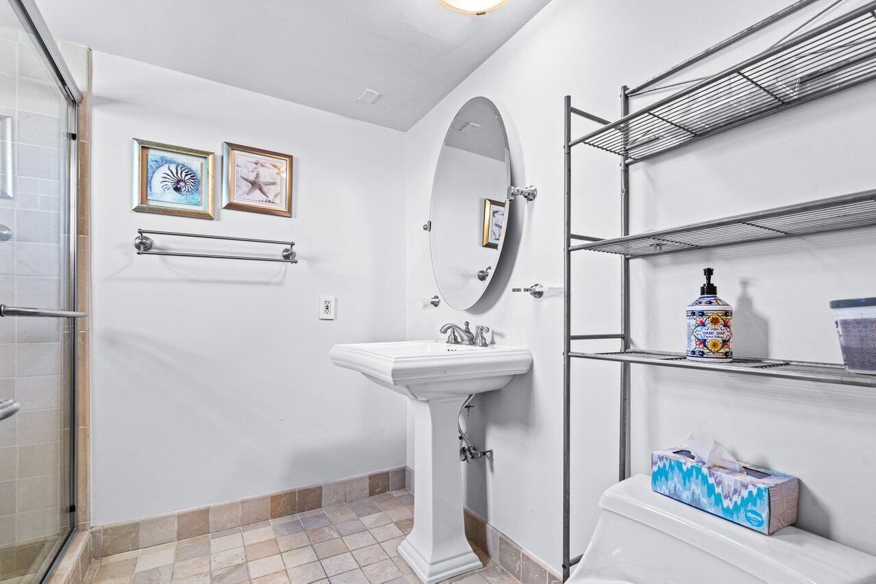 2871 North Ocean Boulevard, Unit C417 Boca Raton, FL 33431 - Photo 19 of 26 a bathroom with a sink and a mirror